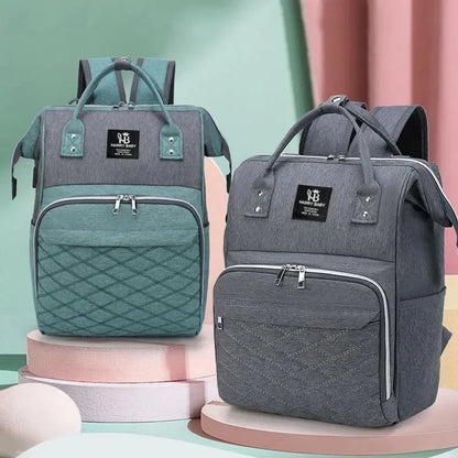 Sac à dos à langer, coloris vert d'eau et gris