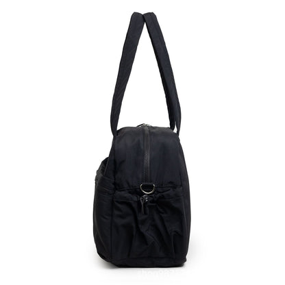 Sac à langer week-end noir vu de profil, poche latérale élastiquée